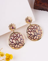 Lotus flower earrings with gold and purple details on a white background