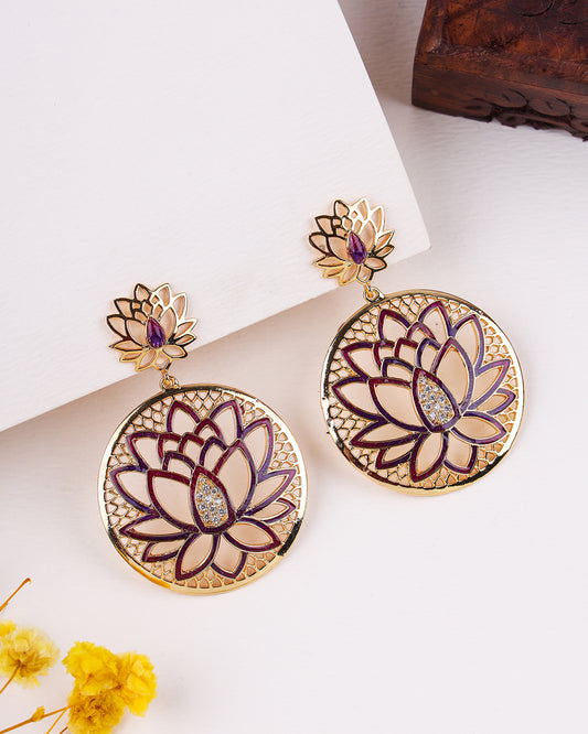 Lotus flower earrings with gold and purple details on a white background