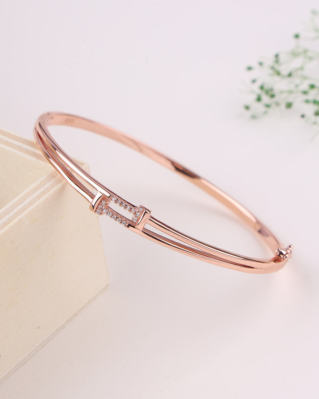 Rose gold bracelet on a light background