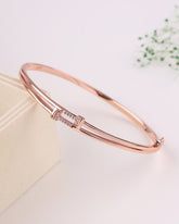 Rose gold bracelet on a light background