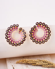Pair of 925 sterling silver earrings with pink and gold accents on a white surface.