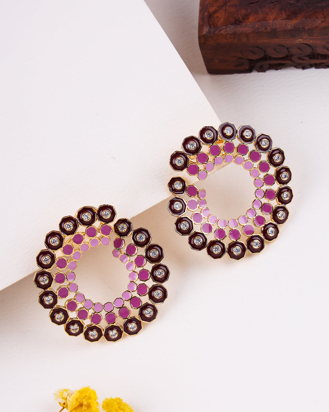 Pair of 925 sterling silver earrings with pink and gold design on a white background