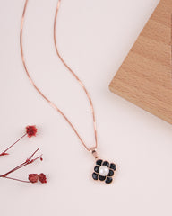 Necklace with a floral pendant on a light surface with dried flowers.