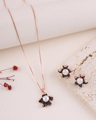 Jewelry set with necklace and earrings featuring pearls on a light background