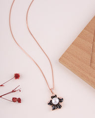 Necklace with a black and white pendant featuring a pearl on a light surface.