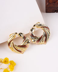 Gold hoop earrings with a textured design on a light background