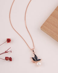 Necklace with a black leaf pendant and pearl on a light background