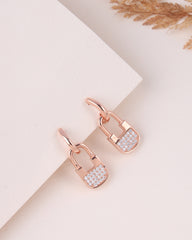 Rose gold lock-shaped earrings with diamond accents on a light background