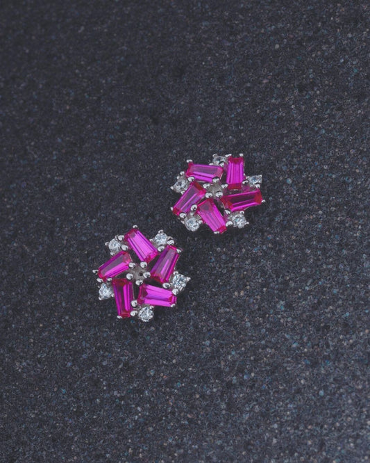 Pair 925 Sterling silver of pink gemstone earrings on a dark gray background