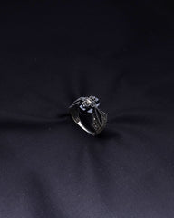 Silver ring with a diamond on a black fabric background