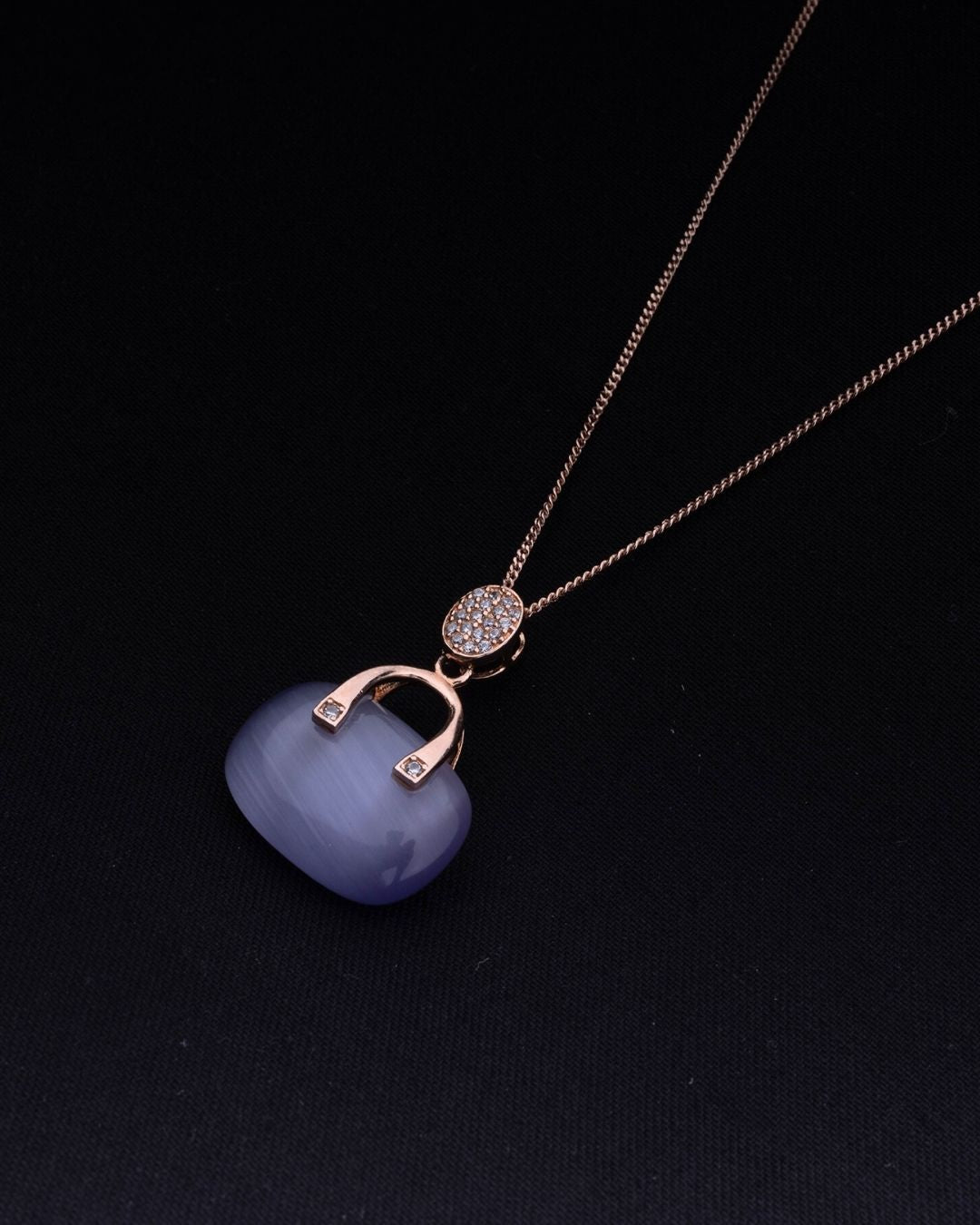 925 Sterling silver Necklace with a blue pendant and gold chain on a black background