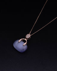 925 Sterling silver Necklace with a blue pendant and gold chain on a black background