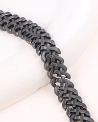 Close-up of a black chainmail bracelet on a white background