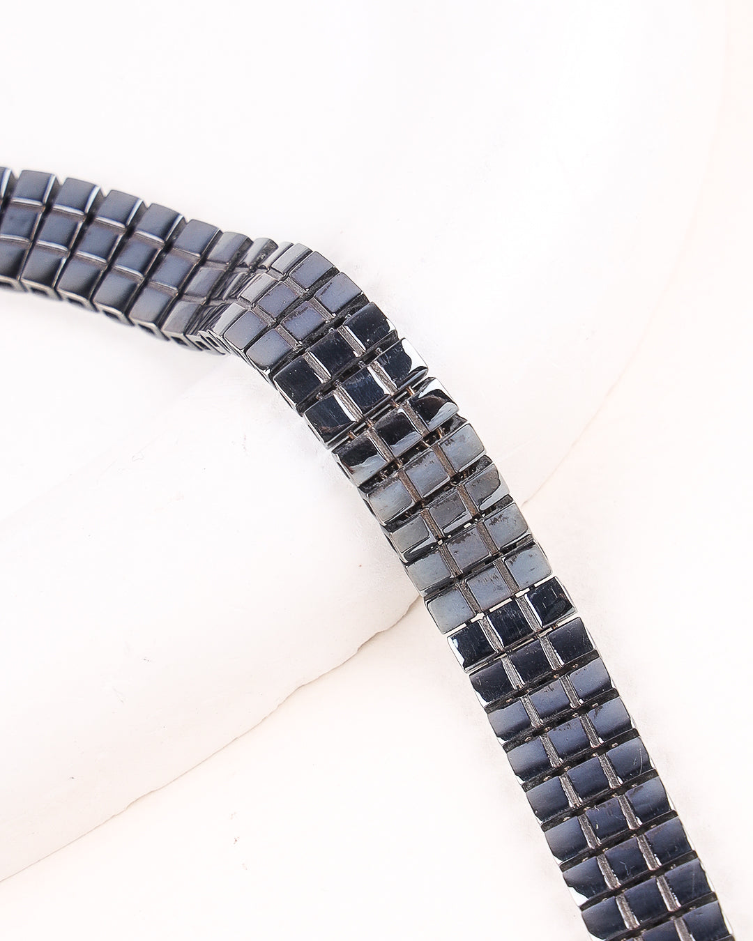 Close-up of a black and gray beaded bracelet on a white background