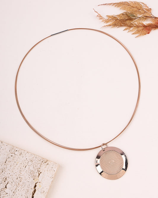 Rose gold necklace with a round pendant on a light background