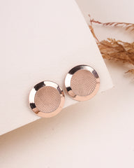 Rose gold earrings on a light background