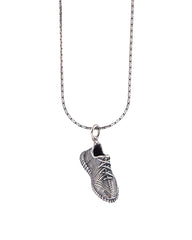 Silver necklace with a detailed pendant on a white background