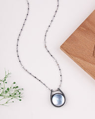 Necklace with a blue pendant on a white background