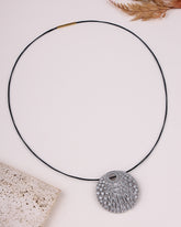 Necklace with a decorative pendant on a light background