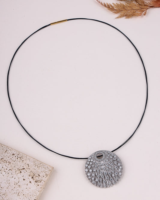 Necklace with a decorative pendant on a light background
