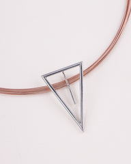 Silver triangle pendant on a pink wire against a light background