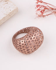 matte rose gold ring with a unique design on a light background