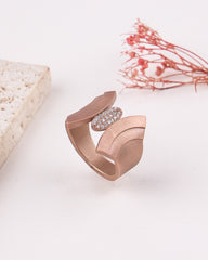 Rose gold ring with a diamond clasp on a light background