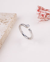 Silver ring with a diamond on a light background