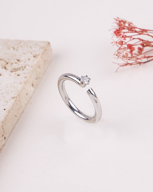 Silver ring with a diamond on a light background