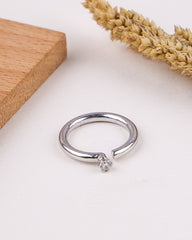 Silver ring with a small gemstone on a light background