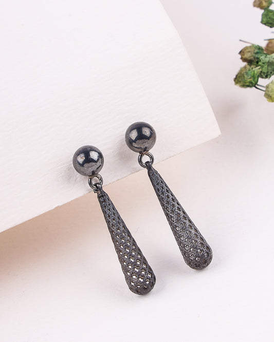Pair of black earrings on a white background