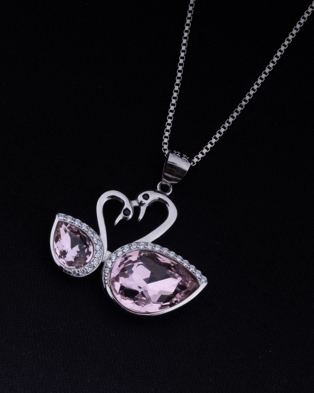 925 Sterling silver Pink swan-shaped pendant on a chain against a black background