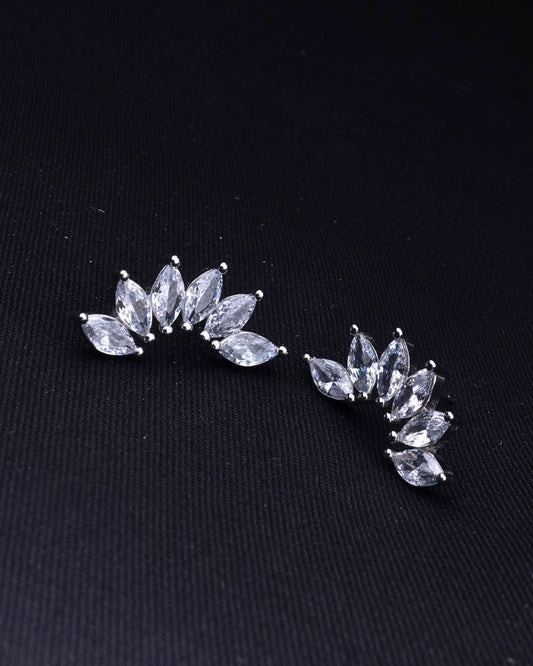 Pair of silver leaf-shaped earrings on a black background
