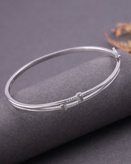 Silver bracelet on a dark gray surface