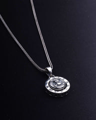 Silver necklace with a pendant on a black background