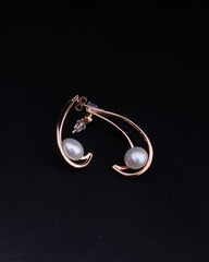 Earring with two pearls on a black background