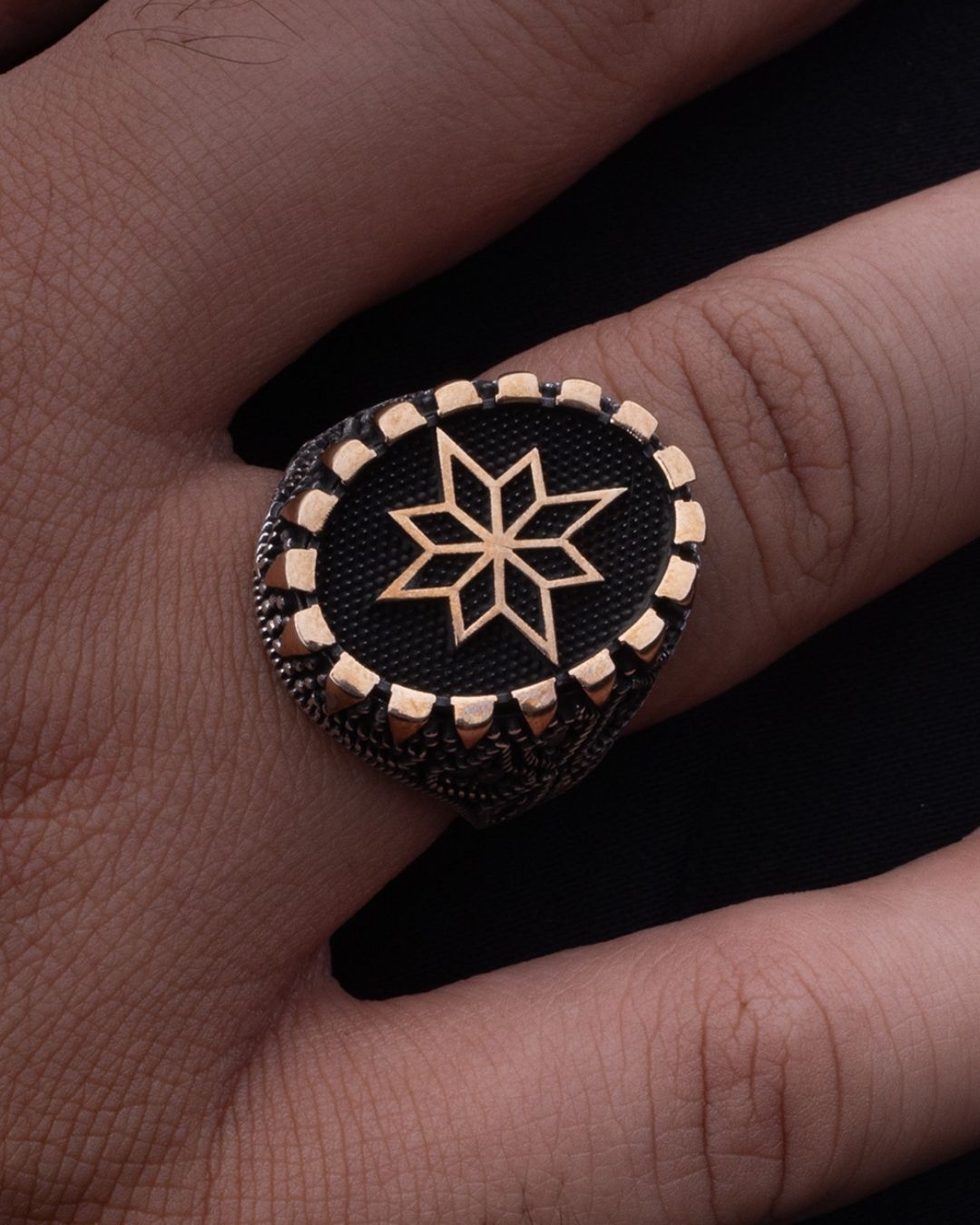 Ring with star design on a finger