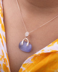 925 Sterling silver Necklace with a blue pendant worn by a person in a yellow floral dress.