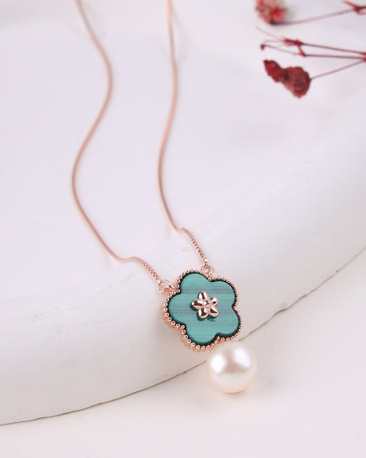 Necklace with a turquoise flower pendant and pearl on a white background