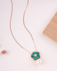 Necklace with a green flower pendant on a light background