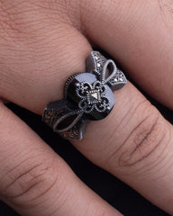 Silver ring with floral design on a finger