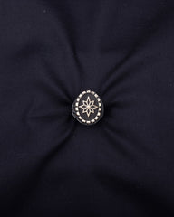 Black fabric with a knotted center and star design brooch