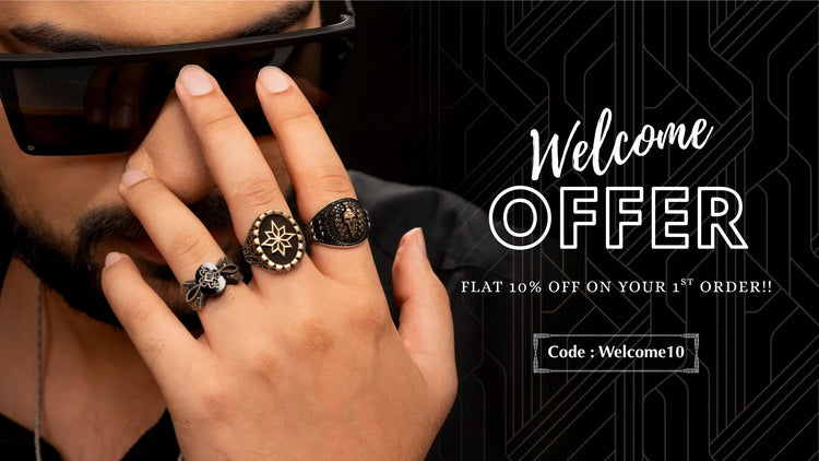 Hand wearing multiple rings with a promotional message on a black background